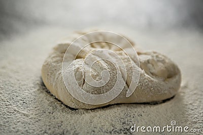 Close up of flour on kneaded dough Stock Photo