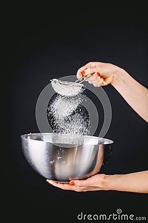 Flour sifting through a sieve for a baking Stock Photo