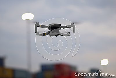 Close up Fly Grey Drone on Port Industrial Jakarta Stock Photo