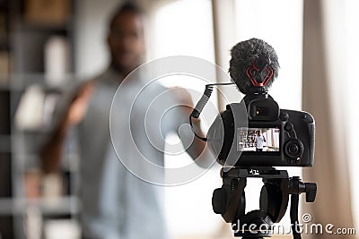 Close up focus on digital camera, showing mixed race man. Stock Photo