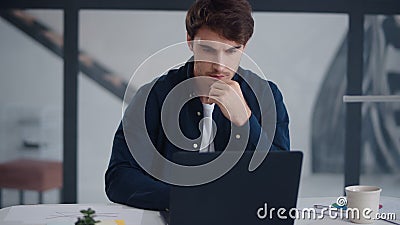 Focused business man working laptop in office. Guy reading text on notebook Stock Photo