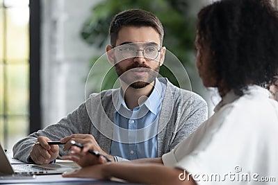 Close up focused businessman talking with african american businesswoman. Stock Photo