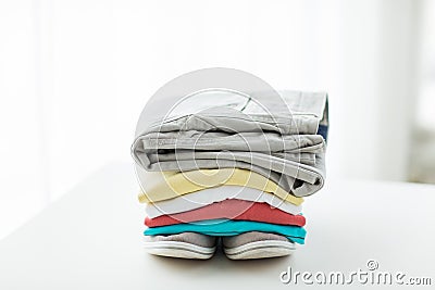 Close up of folded shirts and boots on table Stock Photo
