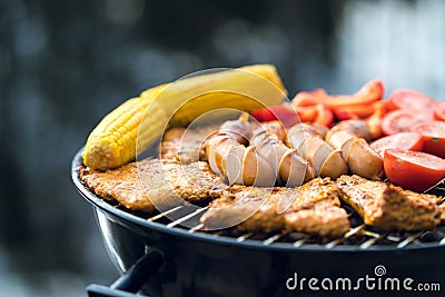 Close up of food grilling on a charcoal kettle grill Stock Photo