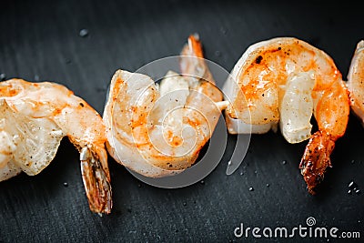 Close up food photo of fried shrimps on black slate background. Asian culture and cuisine. Food image of prawn for design of cafe, Stock Photo