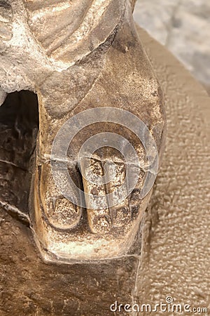 Close-up of foot in sandal with toes showing of ancient greek statue - grainy carved marble against a more blurred background Stock Photo