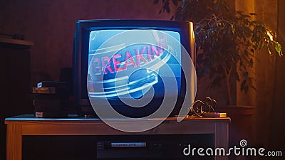 Close Up Footage of a Dated TV Set Screen. Breaking News Report Starting. Intro with Word Breaking Stock Photo