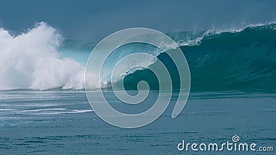 CLOSE UP: Forceful barrel wave splashes ocean water around the coast of Tahiti. Stock Photo