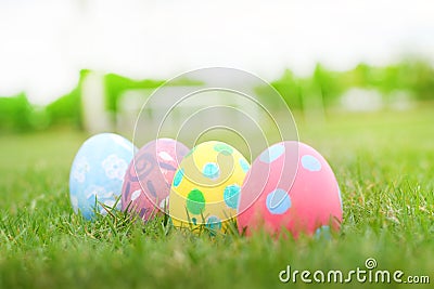 Close up four eggs pastel line in the grass background in ester day. Stock Photo