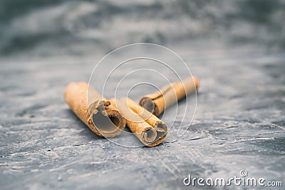 Close up of fragrant cinnamon sticks on vintage dark background Stock Photo