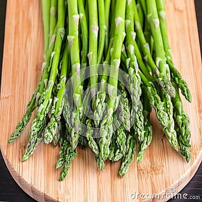 Close up of fresh asparagus on wooden board. Stock Photo