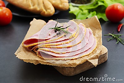 Close up fresh hum meat for sandwiches, dark board with vegetables on background. Stock Photo