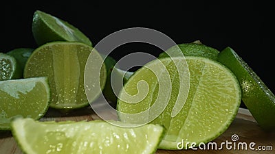 Close-up of fresh lime rests upon a rustic wooden cutting board. Comestible. Stock Photo