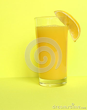 Close Up of Fresh Orange Frozen Granita Slush Drink Garnished with Orange Wedge and Served in Glass with Striped Straw on Stock Photo