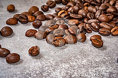 Brown roasted coffee beans closeup grey beton background Stock Photo