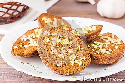 Close-up of fresh rye garlic croutons with dill on a plate Stock Photo