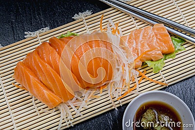 Close up fresh salmon sashimi set salad on bamboo plate, Japanese food. Stock Photo