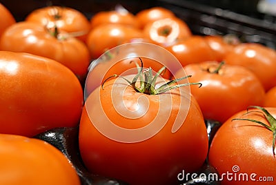 Close up fresh tomato for sale on display rack inside superstore Stock Photo