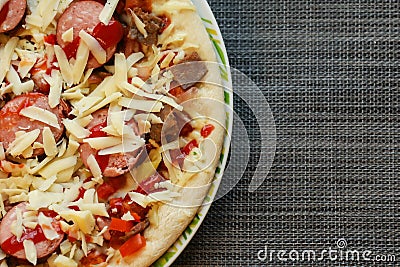 Close up of freshly home made pizza on a white plate with cheese, meat, onions, spicy products. Italian traditional food Stock Photo