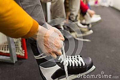 Close up of friends wearing skates on skating rink Stock Photo