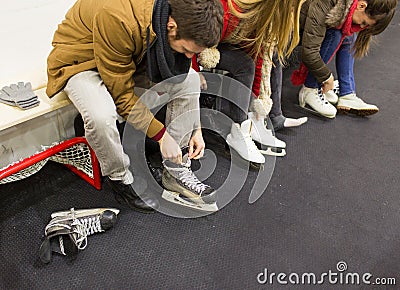 Close up of friends wearing skates on skating rink Stock Photo