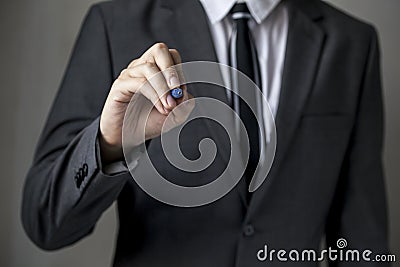 Close-up of front faced businessman is writing on the board Stock Photo