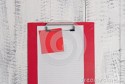 Close up front view colored clipboard blank paper sheet sticky note lying retro old wooden rustic vintage background at Stock Photo