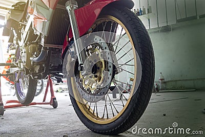 Close up of front wheel of a motorcycle made of iron and rubber on stand Stock Photo