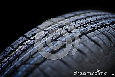 Close-up of frosted car tire wheel profile structure in front of black background. Stock Photo