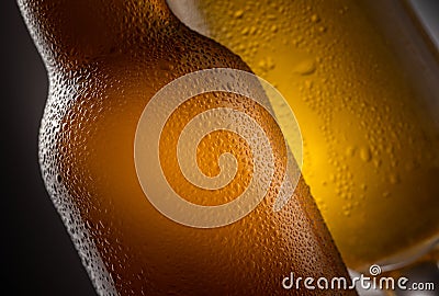 Close up of a full beer bottle cold beer condensation with a full glass detail Stock Photo