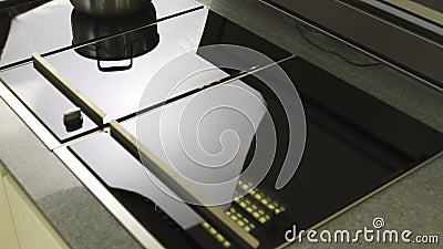 Close up of functional kitchen induction hob in a new flat. Household utensils. Details of interior, an induction Stock Photo