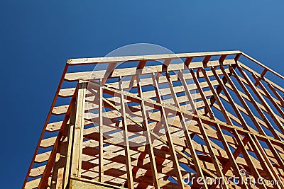 Close-up of gables roof on stick built home under construction and blue sky Stock Photo