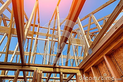 Close-up of gables roof on stick built home under construction and blue sky Stock Photo