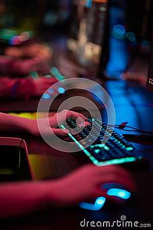 Close-up of the gamers hand movements on the glowing keyboard and mouse Stock Photo