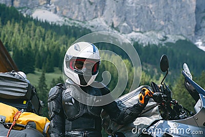 Close up of girl dressed in protective suit of body armor, tutle prtotective jacket, with helmet and glowes. Adventure motorcycle Stock Photo