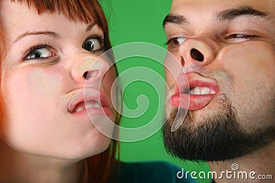 Close up girl with red hair and guy grimace mash Stock Photo