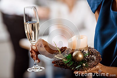 Close up of girl`s hand holding glass with cahmpagne. Stock Photo