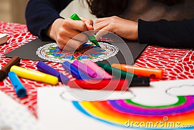 Close-up of girl`s hands coloring a mandala Stock Photo