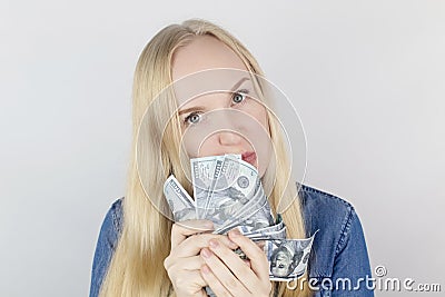 Close-up of a girl sniffing money. Madness and greed from currency. The concept of corruption and getting money at any cost. Stock Photo