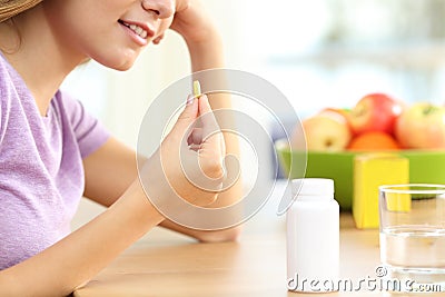 Close up of a girl taking vitamin pill Stock Photo