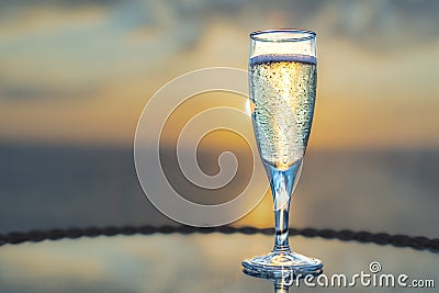 Close-up of a glass of champagne at sunset. Stock Photo