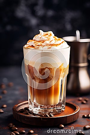 Close-up of a glass of Dalgona Coffee with cinnamon on dark background, vertical image of homemade coffee drink. Coffee latte made Stock Photo