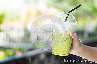 Close up glass of ice matcha green tea on wood table, selective focus Stock Photo