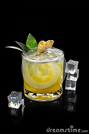 Close up glass of orange cocktail decorated with a pinapple Stock Photo