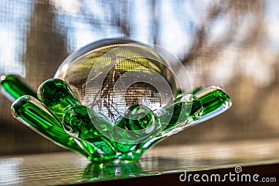 Close up of the glass souvenir figurine placed on the window Stock Photo