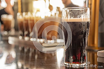 Close up of a glass of stout beer in a bar Stock Photo