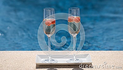 Close up of glasses with champagne or prosecco with raspberry Stock Photo