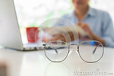 Close up glasses with lawyer, handwriting civil and criminal indictment on the desk with glasses and coffee working at the home Stock Photo