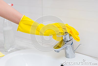 Close up of gloved hand cleaning sink Stock Photo