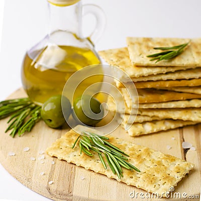 Close up of gluten free crackers with rosemary, olives and olive oil Stock Photo